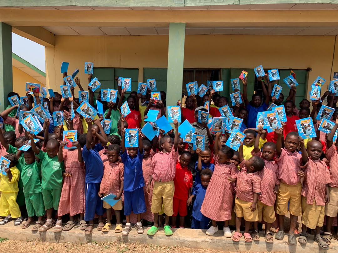 Children celebrating with their new Amira books