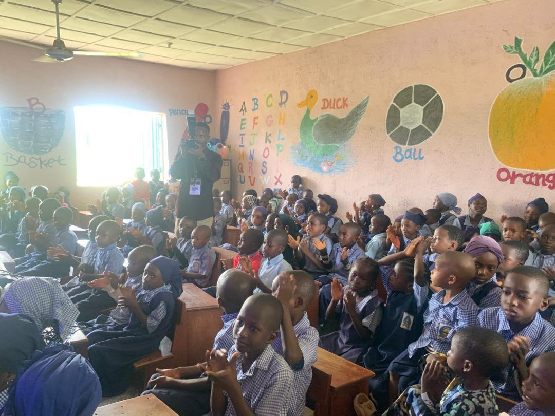 Children clapping along during a classroom screening